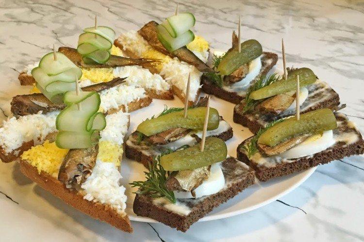 Canapés avec des sprats sur des brochettes